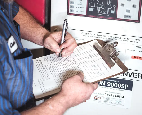 Service technician going through maintenance checklist